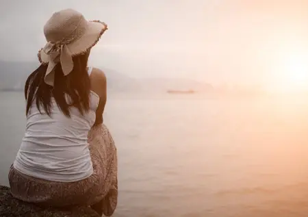 Lady sitting by the beach